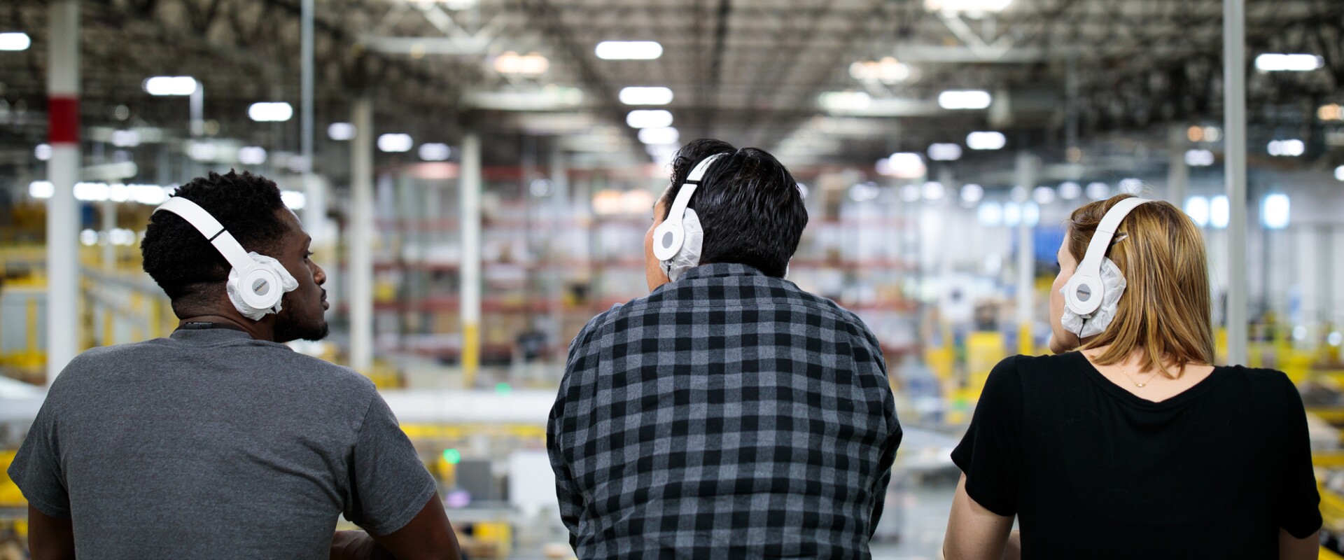 Three guests look over the Fulfillment Center