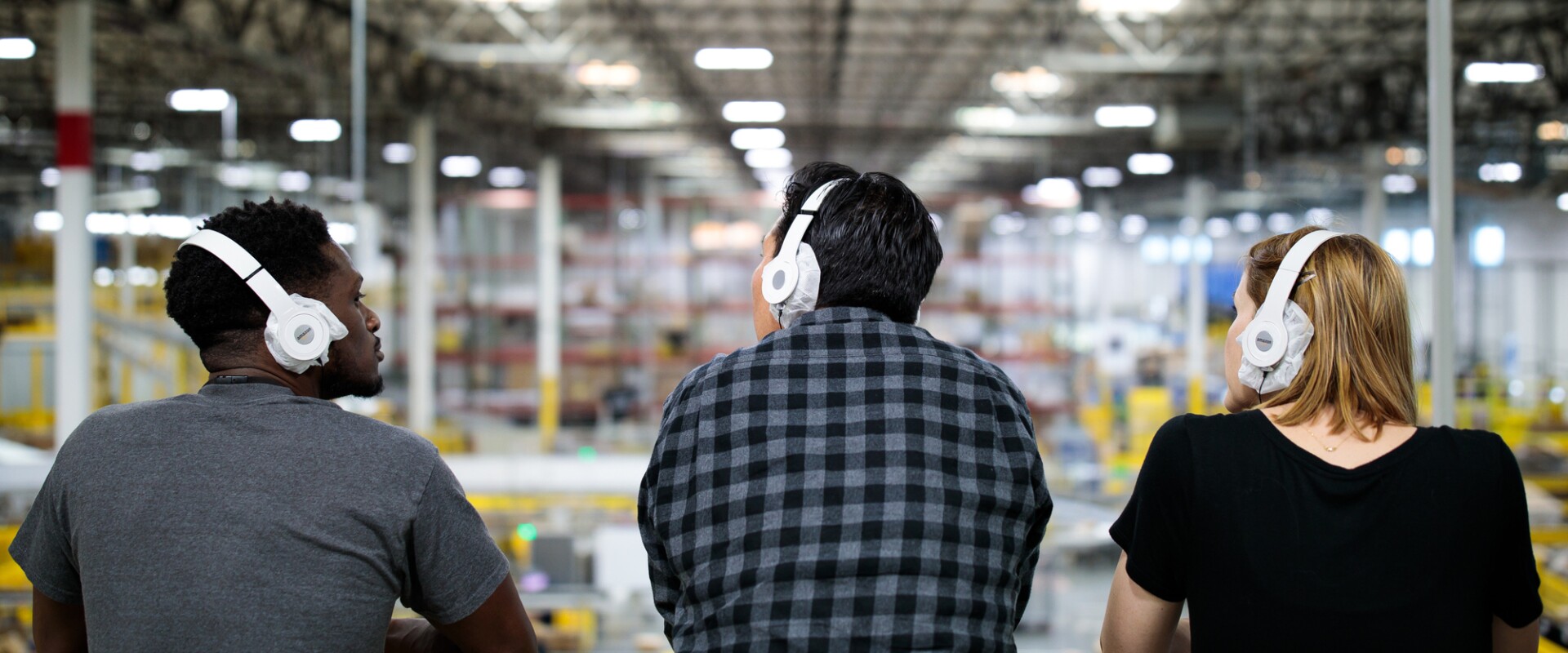 Three guests look over the Fulfillment Center 